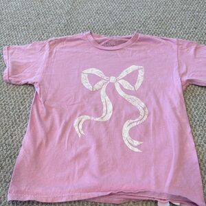 A pink T-shirt with a bow on it.